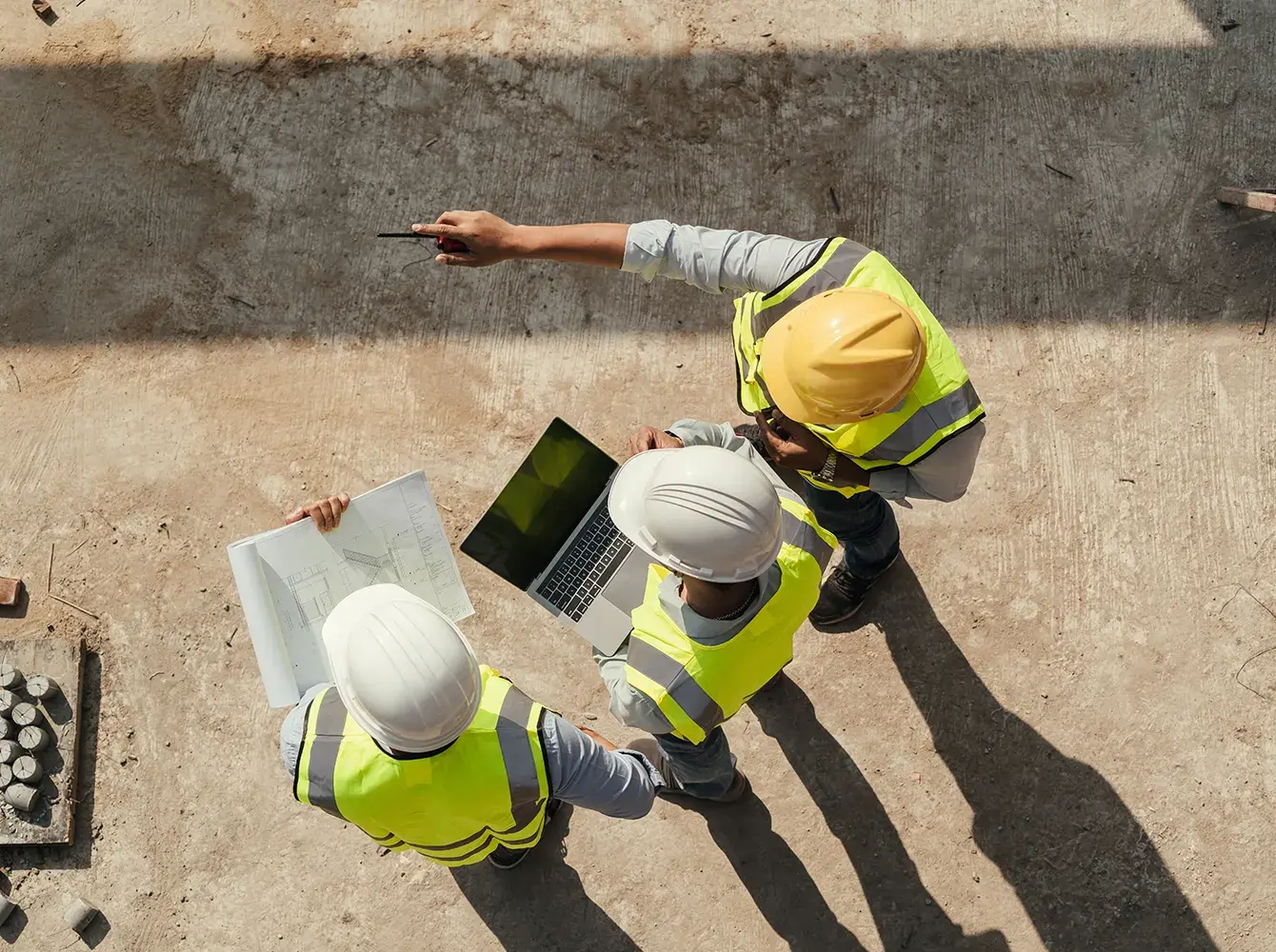 construction-team-reviewing-blueprints-on-site